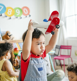 Boy playing with toy plane