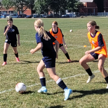 Soccer academy students practicing outsides